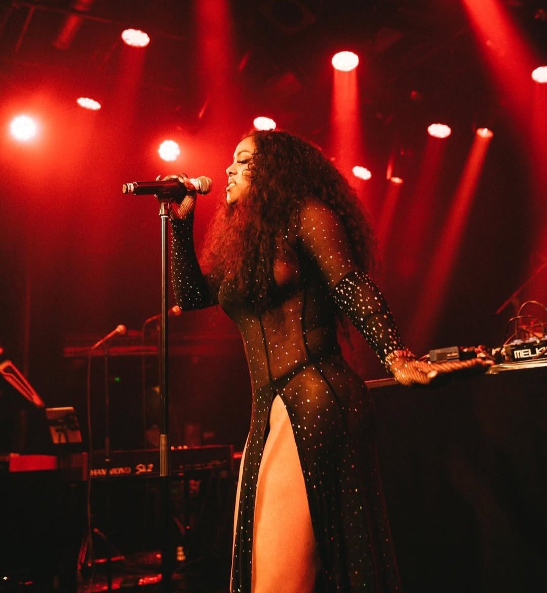 La Toya Linger performing live under red stage lights